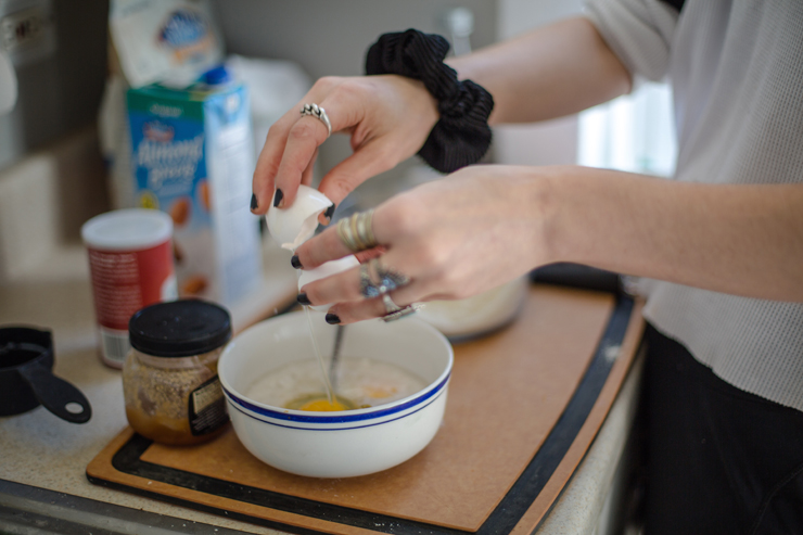 cracking eggs into a bowl